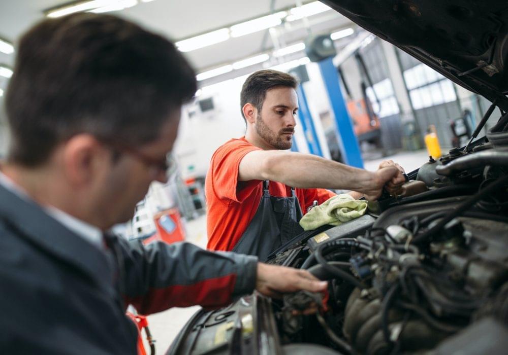 Professional car mechanic changing motor oil during expert oil change Arlington TX at Arlington Auto Pros service shop And learn more about-us